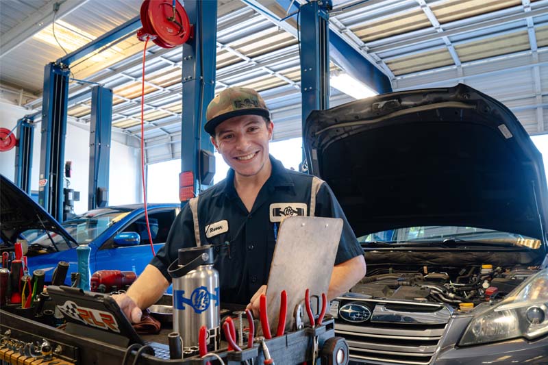 M45 Automotive technician performing scheduled maintenance on a Subaru in Auburn, CA